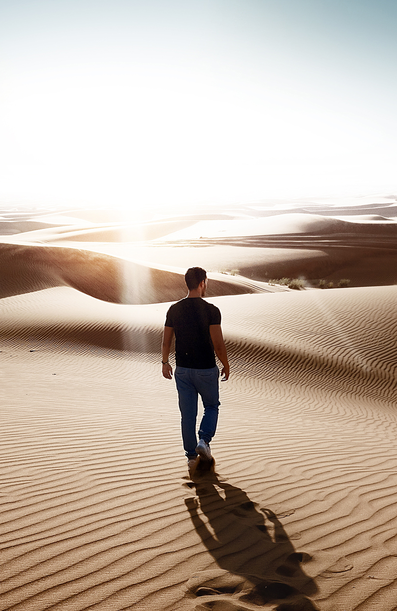 dubai-united-middle-east-man-walking-in-sand-sidebar