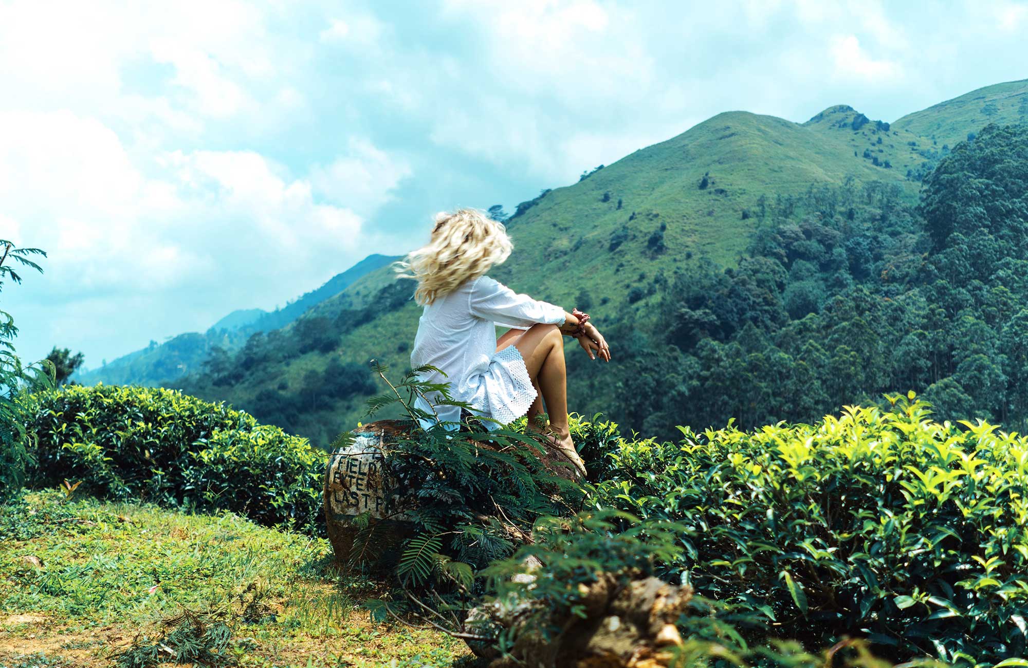Bakpokaferðalangur situr á stein í frumskóginum í Sri Lanka