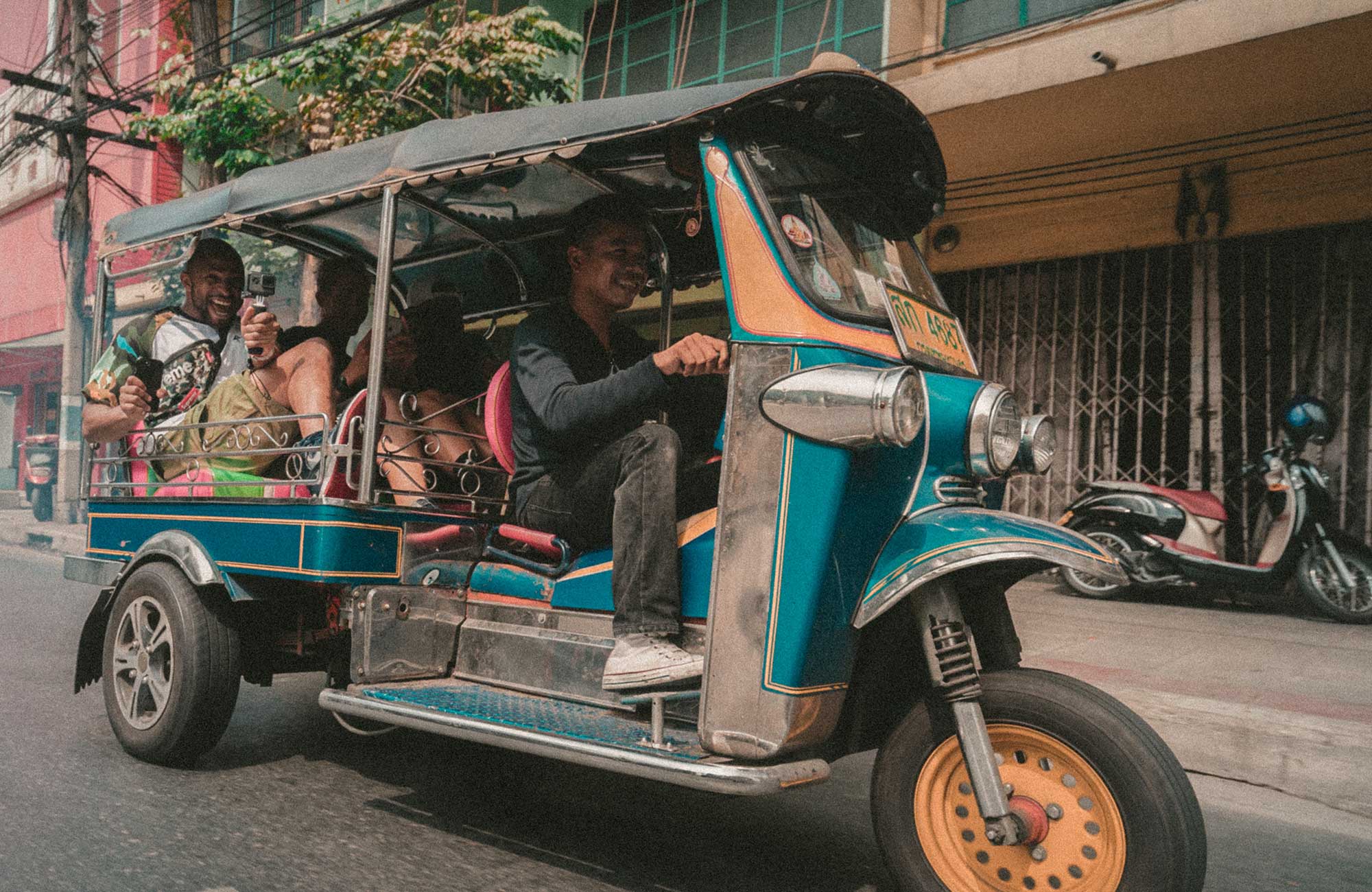 Two backpackers in a TukTuk in Asia